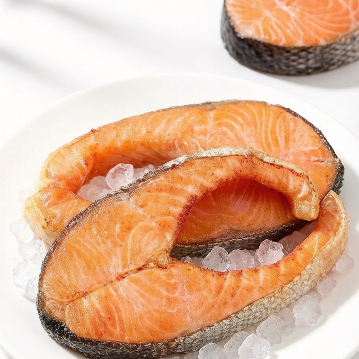 Thick cross-cut salmon steaks with creamy marbling on crushed ice